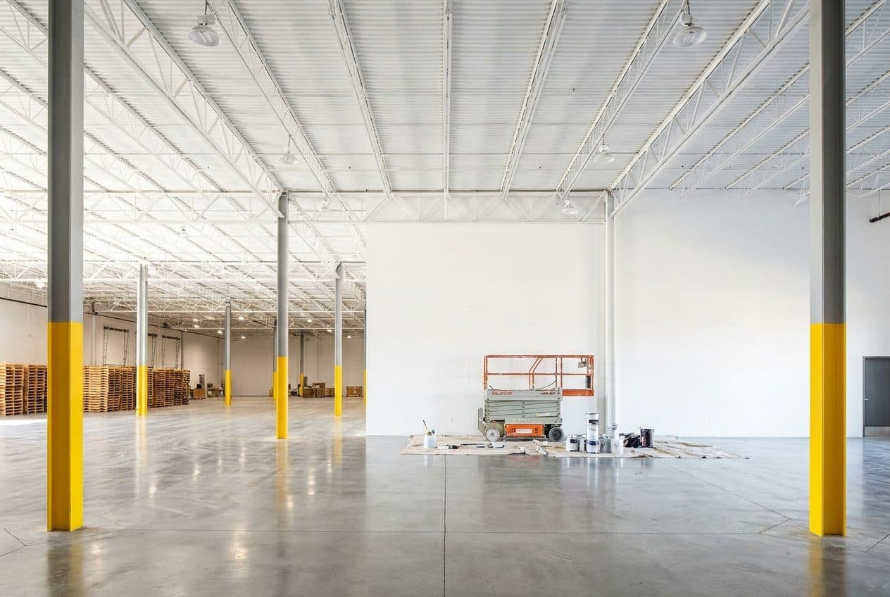 Freshly painted warehouse interior with white walls and ceiling deck